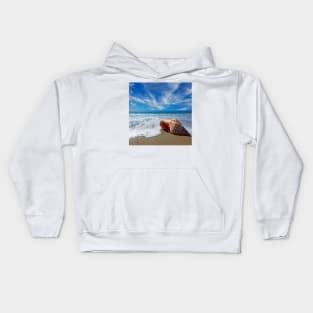 Beach with conch shell under blue sky Kids Hoodie